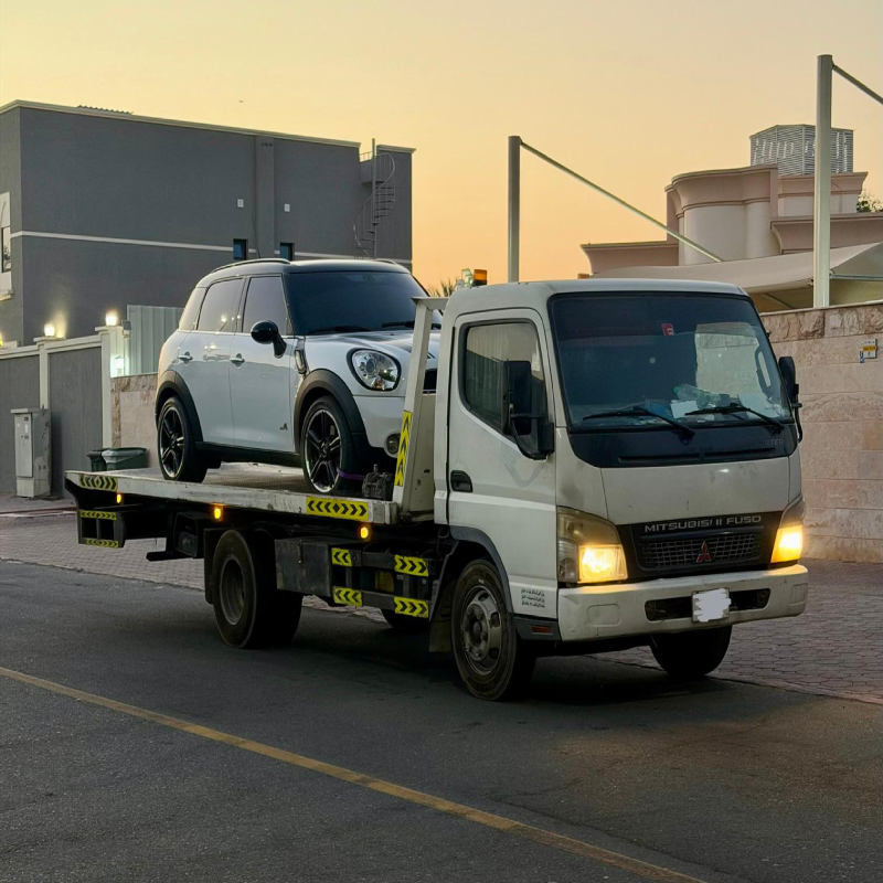 Vehicle secured on a flatbed tow truck in Dubai